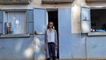 Volunteer in front of a home