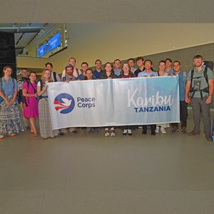 Group of trainees pose with Tanzania banner.