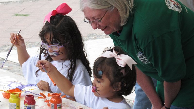 Mary engages a child at an outreach event in Mexico.