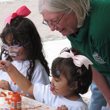 Mary engages a child at an outreach event in Mexico.
