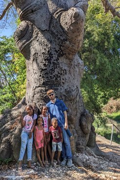 Briley Lewis with kids in front a tree