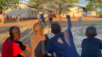 Boys Sitting Down Watching a Soccer Game in Namibia