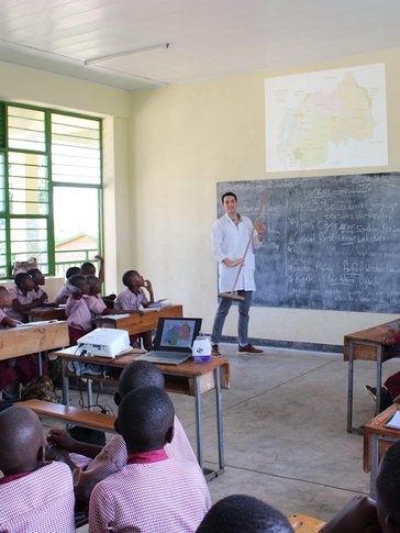 Education Volunteer teaches English while being interactive with his students.