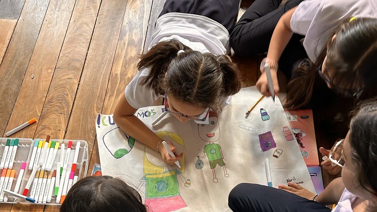 4th grade students make posters for a recycling program Gabriella started at the elementary school.