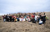 Group photo capturing around 80 people, at the end of the tree planting activity.