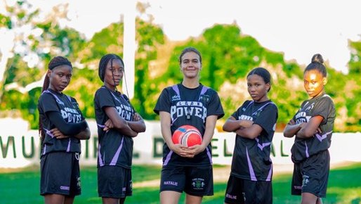 Natalie with members of the girls' soccer team she supports in the Dominican Republic.