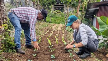 PCV and counterpart working in a garden