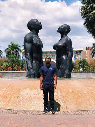 Don Holly poses with statues.