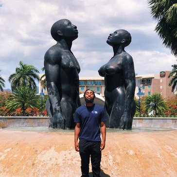 Don Holly poses with statues.