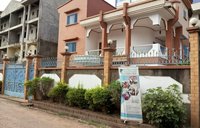 Brick building with metal fence and a sign out front