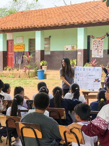 A presentation at a school about the importance of hydration, taught alongside a community health worker