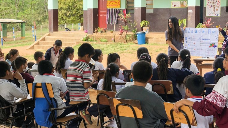 A presentation at a school about the importance of hydration, taught alongside a community health worker