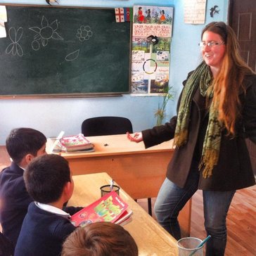 Volunteer teaching students in a classroom.