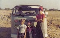 The author as a child stands with her family in front of a VW bus.