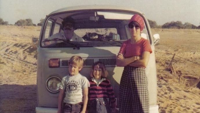 The author as a child stands with her family in front of a VW bus.