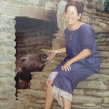 A Peace Corps Volunteer sits on the steps of her home in Nepal.