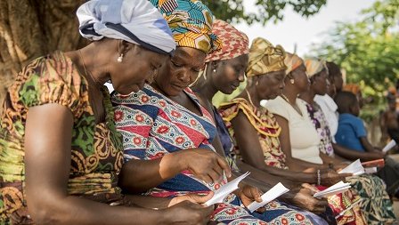 a group of women reviewing a document