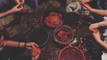 People cutting red peppers