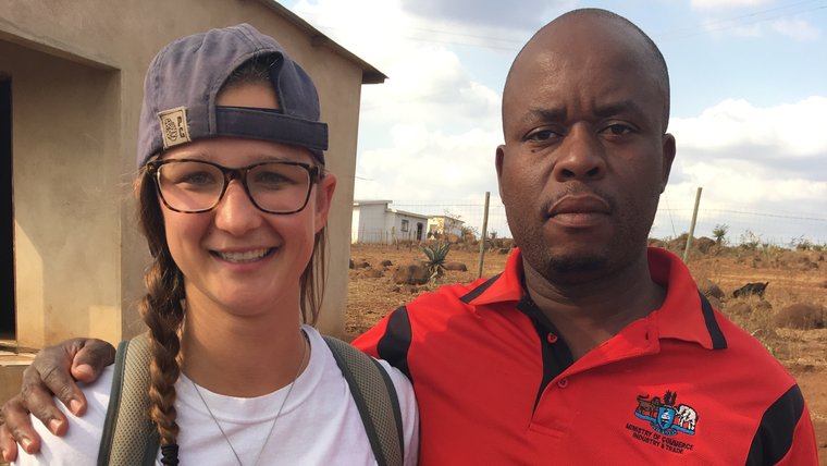 A Peace Corps Volunteer in Eswatini stands with a local friend.