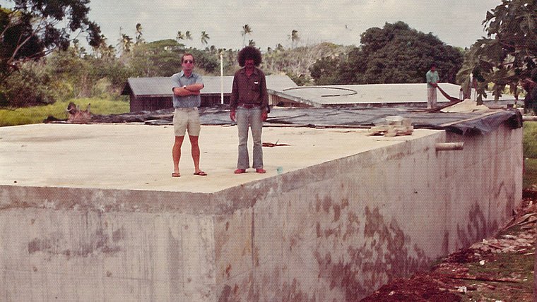 .      A Tongan construction foreman and I are standing on a concrete reservoir I designed.