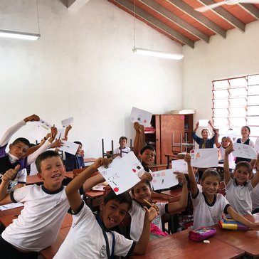 Fourth grade students at the Escuela Basica show off their finished personal flags, an activity meant to address self-esteem 