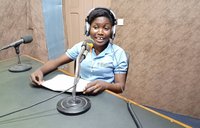 A woman speaks into a microphone