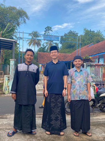 Ben in religious attire with a friend and his host brother during Eid al-Adha, an Islamic festival.