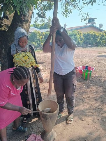 Marie teaches pregnant women how to make soda soap (laundry detergent) to help prevent infection in their communities.