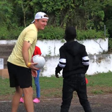 Brad plays soccer with a Jamaican boy.