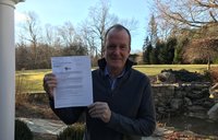 Bryan Lynch holds paper
