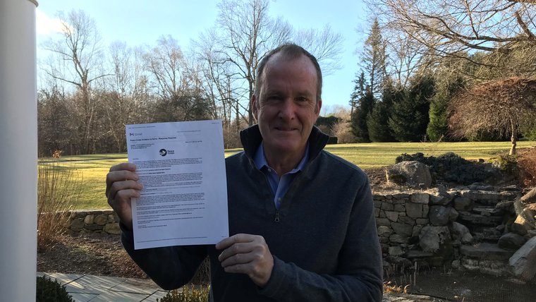 Bryan Lynch holds paper