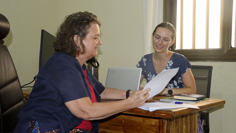 Brianna and Peace Corps Togo's director of programming and training review Brianna's work plan