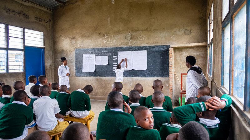 PCV Brina coteaching with a student at the chalk board