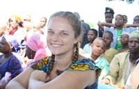 A Peace Corps Volunteer watches a celebration in her community in Cameroon.