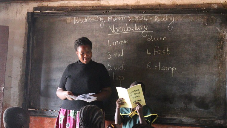 Volunteer Ernestine reads with her students in Liberia.