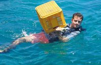 Carrying a crate for coral at coral gardening training