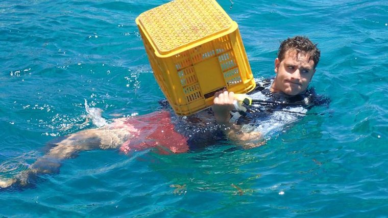 Carrying a crate for coral at coral gardening training