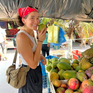 Claire enjoys learning about local foods and meeting new people at the local market in Belize.