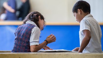 Kids read a book in Colombia
