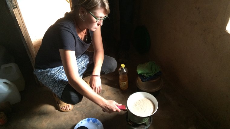 Volunteer Chris B. cooking pancakes in Tanzania