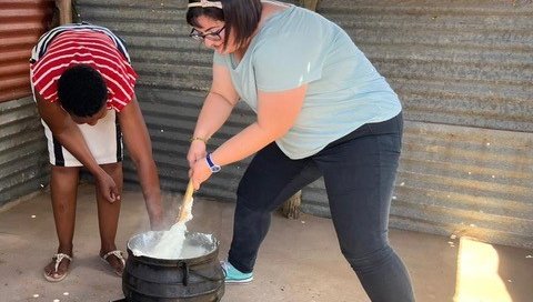 Corinne cooks "pap," a traditional South African staple food made of maize (corn).