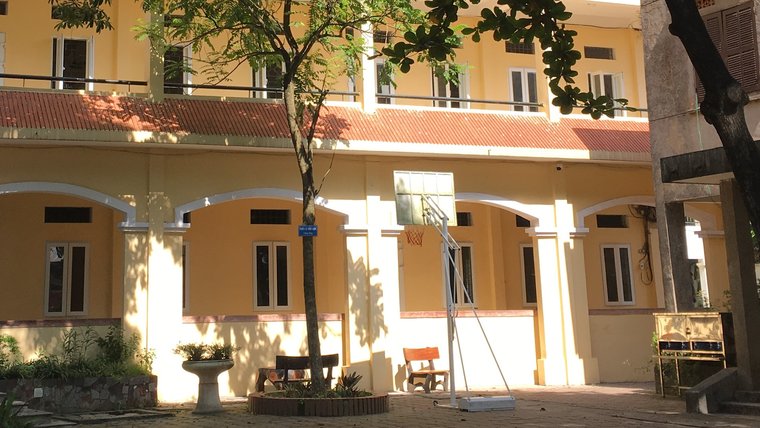 Sunlight, shade and basketball net in the courtyard of a Hanoi school.