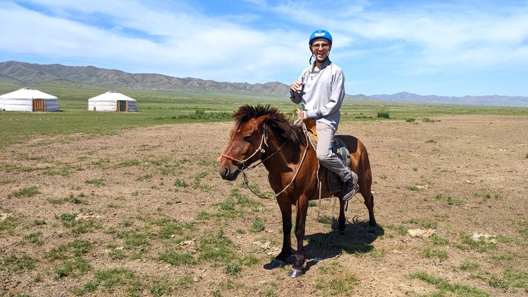 Peace Corps Volunteer Daniel L riding a horse in Mongolia
