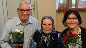 Older American man celebrates birthday with Moldovan grandmother and wife
