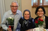 Older American man celebrates birthday with Moldovan grandmother and wife