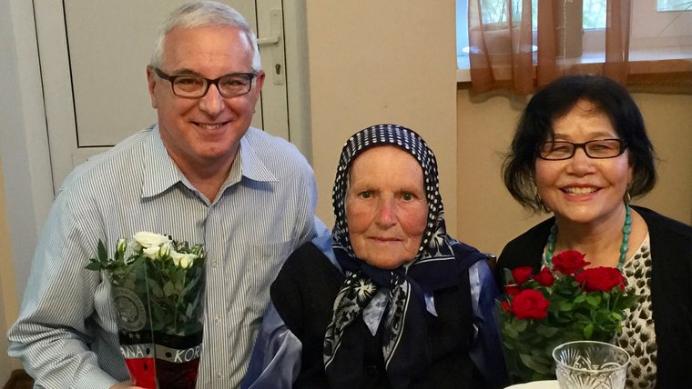Older American man celebrates birthday with Moldovan grandmother and wife