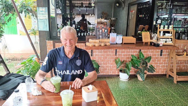 Enjoying Thai tea at a local eatery in Thailand.