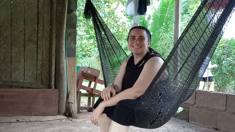 Dena, a female Peace Corps Volunteer, sits in a hammock in Panama