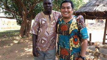 Volunteer Dennis with his host father in Zambia