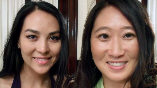 Two women smile side by side for an up-close selfie